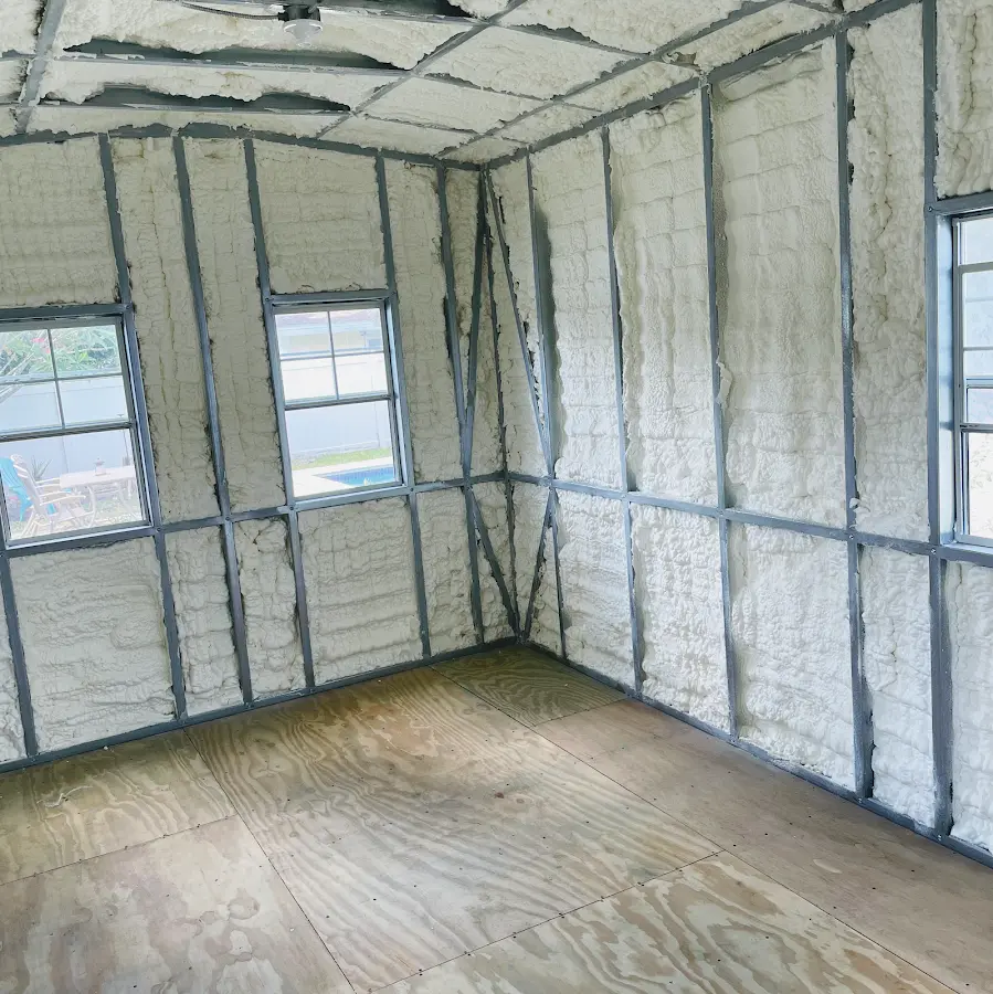 Closed-cell spray foam insulation applied to wall cavities in a residential project in Commerce
